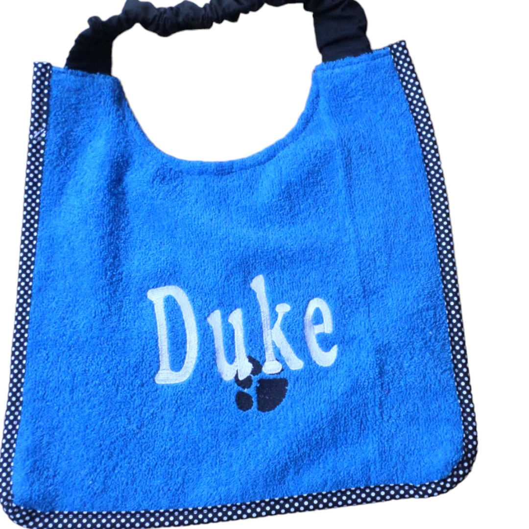 Brand new dog bib ready made with name Duke and paw design. Royal blue towelling and white embroidery