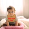 baby wearing cute personalized bib with name embroidered